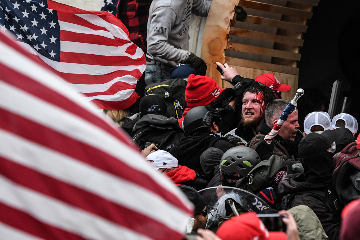 A mob egged on by U.S. President Donald Trump clashes with police at the west entrance of the Capitol in Washington on Jan. 6.